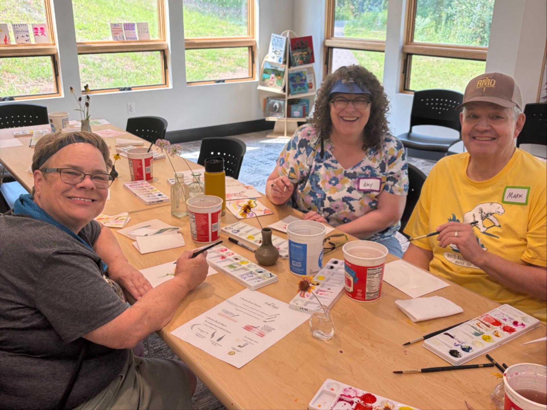 group around a table painting